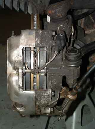 Overall photo showing how the wires leave the brake pad area.  Note the wires are secured under the spring, against the retaining rod