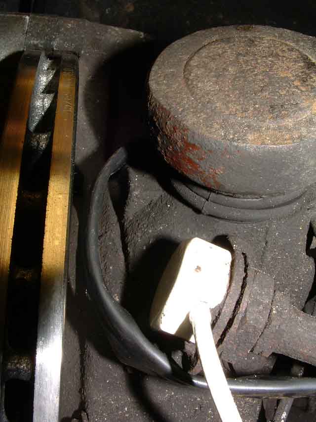 In this route we've chosen to run the wire in front of the upper ball joint. This puts it perilously close to the rotor, so clamp it well to prevent movement. Since the wire and steering knuckle move together this does not pose too much of a problem